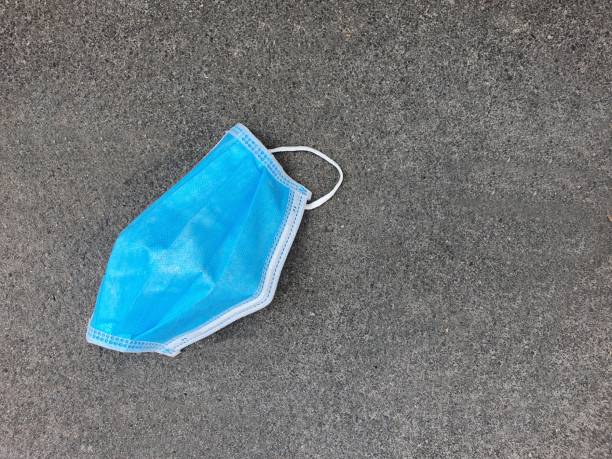 istock surgicl mask on asphalt road 1218029586