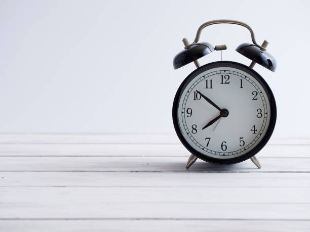 istock Old clock on white wooden plank floor vintage style. 1218029828