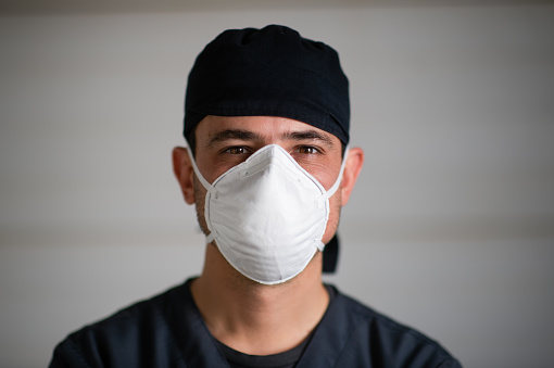 Doctor in scrubs and face mask front view portrait headshot during lockdown in South Africa