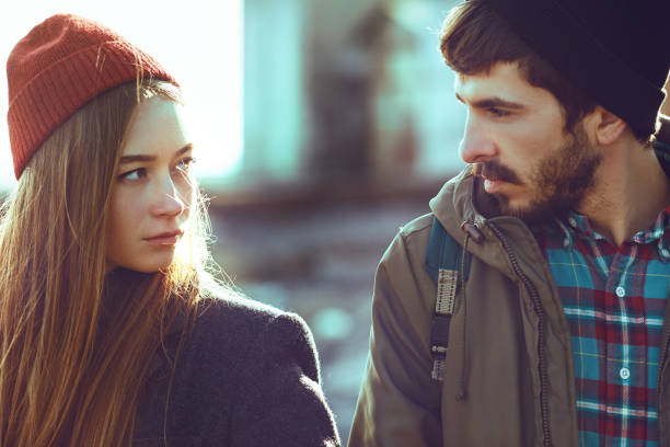 istock Young hipster couple hiking on a rocky beach 1218031139