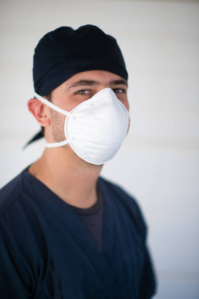 istock Doctor in scrubs and face mask headshot 1218031327