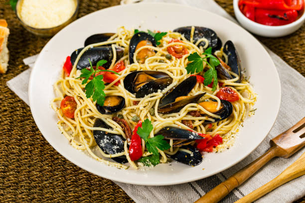 istock Spaghetti with Mussels and Tomatoes on Wooden Background 1218031582