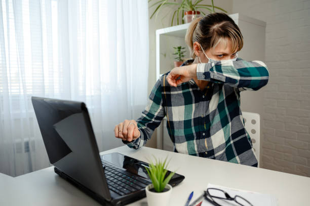 istock Child sneezing, coughing into his sleeve to prevent spread virus 1218031814