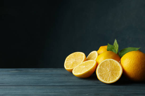 istock Fresh lemons and leaves on wooden table. Ripe fruit 1218033162