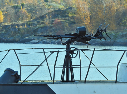 Old decommissioned machine gun on the deck of a submarine in Suomenlinna island, Helsinki, Finland.