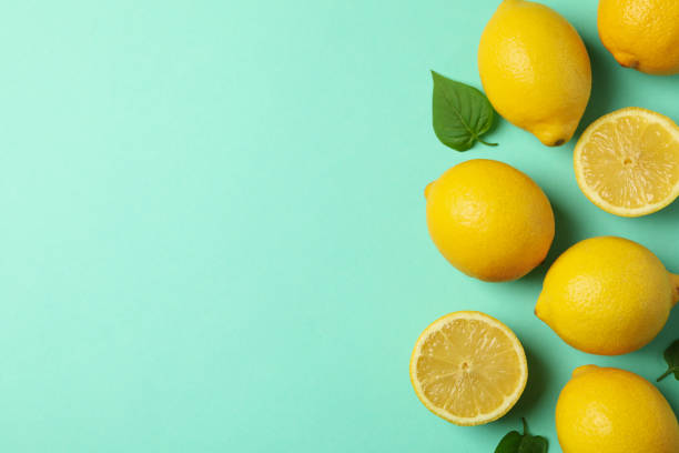 istock Fresh lemons on mint background, top view. Ripe fruit 1218033220