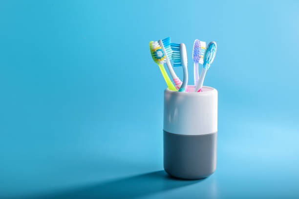 istock Plastic colorful toothbrushes in cup 1218033319