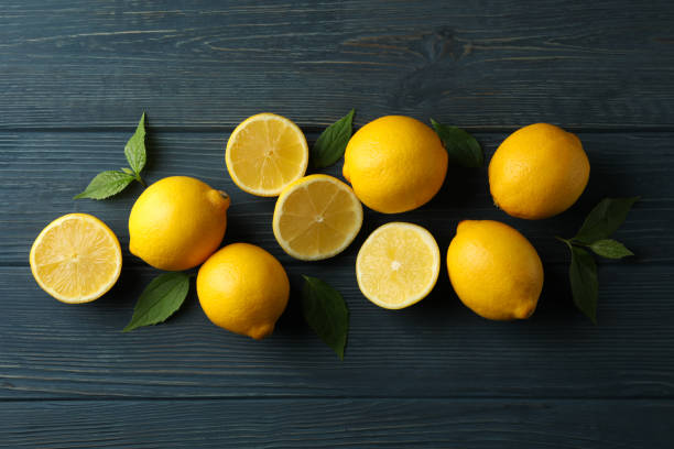 istock Fresh lemons on wooden background, top view. Ripe fruit 1218033437
