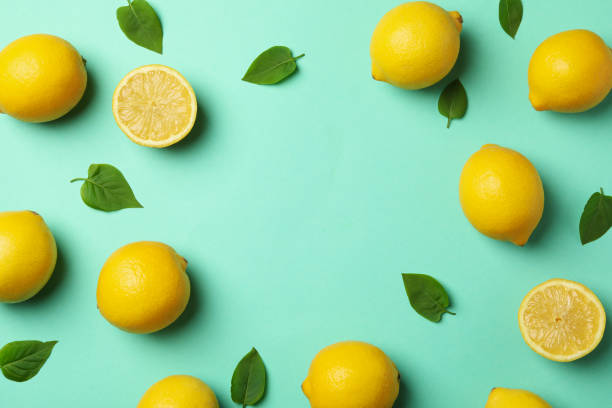 istock Fresh lemons on mint background, top view. Ripe fruit 1218033455