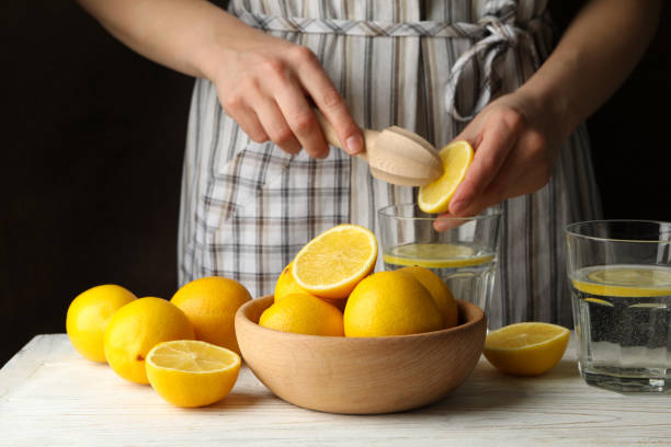 istock Woman squeezes juice. Composition with lemons. Ripe fruit 1218034177