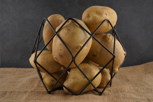 istock Fresh patato on dark background 1218034386