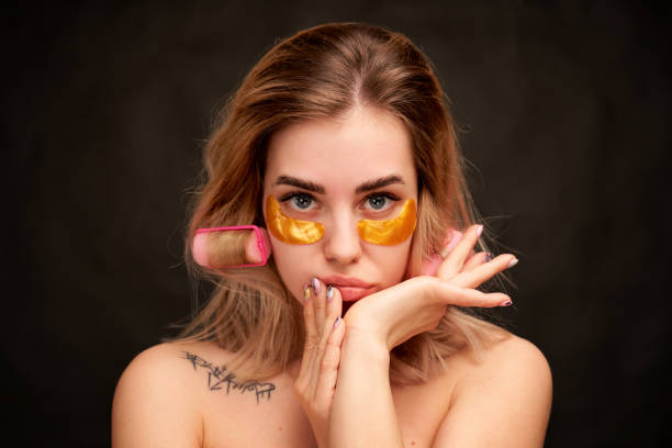 istock Closeup girl touches face hands looks thoughtfully 1218034483