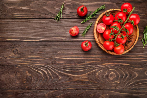 istock Red ripe cherry tomatoes on wooden table 1218034769