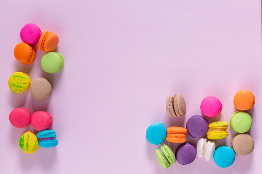 Delicious and colorful macaroons on pink background. Photo taken in studio.