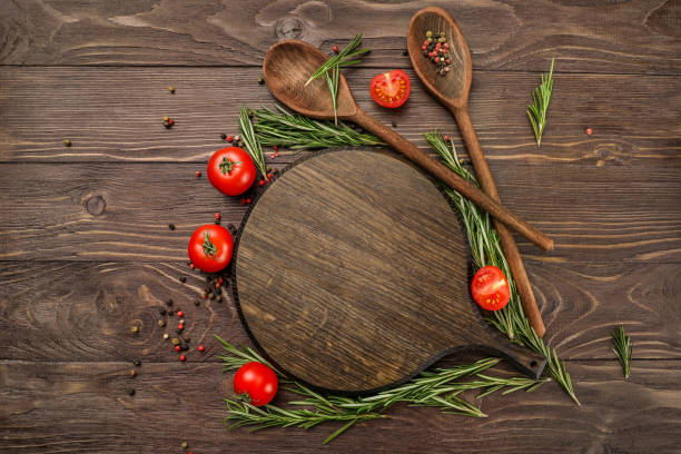 istock Red tomatoes, wooden spoons and cutting board 1218038230