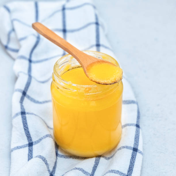 istock Indian ghee (clarified butter) with wooden spoon 1218038501