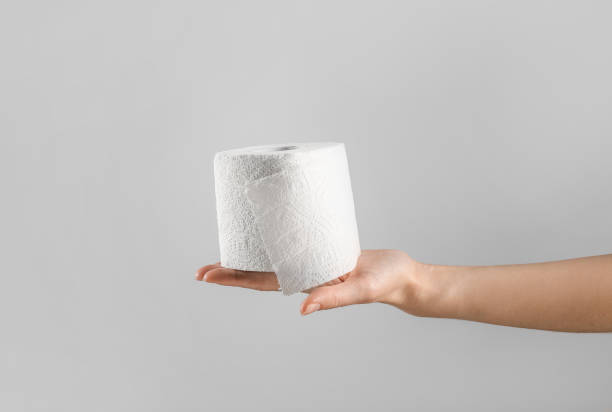 istock Hand holding toilet paper roll 1218039262