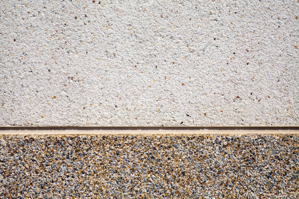 Wall covered with small stone pieces, light up and dark on the baseboard, both available for copy space purposes.