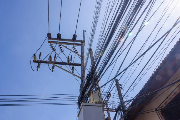 istock Messy and untidy electrical cables hanging from an electricity pole in Thailand 1218044941