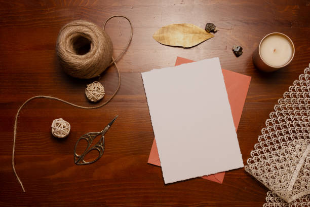 istock Template for invitations and greetings. Card on a wooden background, envelope, decorative stones, pencil. 1218047032