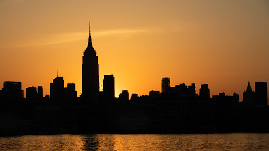 The classic midtown Manhattan skyline is silhouetted by a glorious winter sunrise