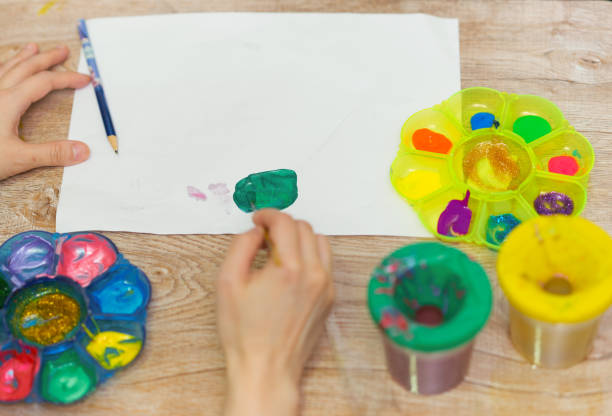 istock hands on art work with color palette and paper 1218048687