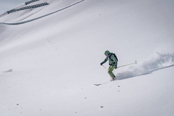 istock Backcountry skier descends mountain 1218052479