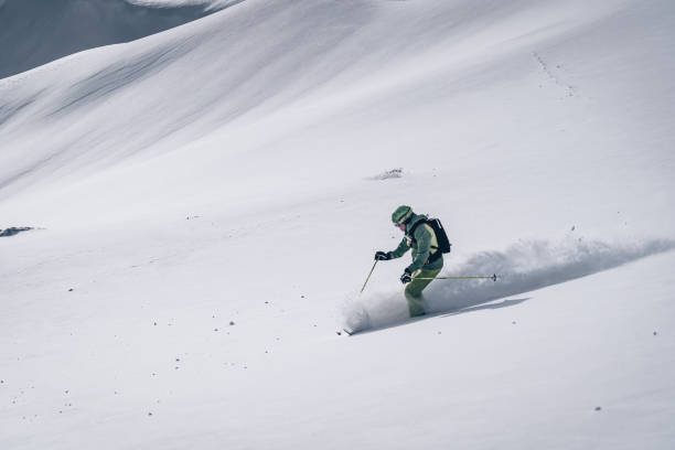 istock Backcountry skier descends mountain 1218052610