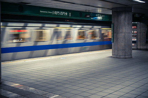 Taipei, Taiwan - October 10, 2013: MRT subway train leaving MRT station