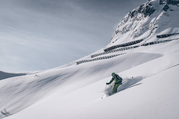 istock Backcountry skier descends mountain 1218052756