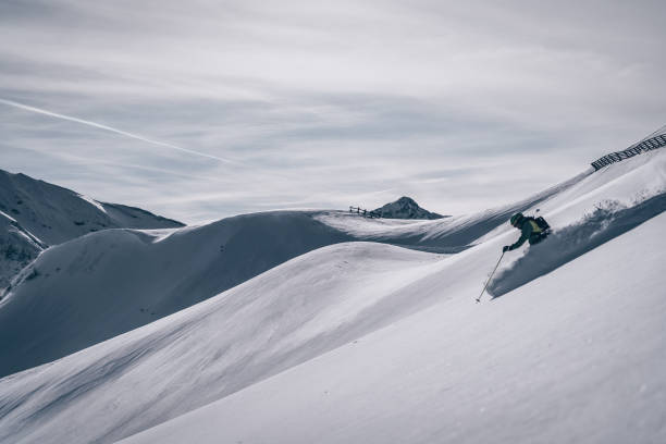 istock Backcountry skier descends mountain 1218052763