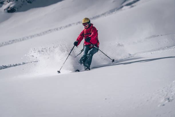 istock Female backcountry skier descends mountain 1218052786