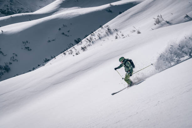 istock Backcountry skier descends mountain 1218052805