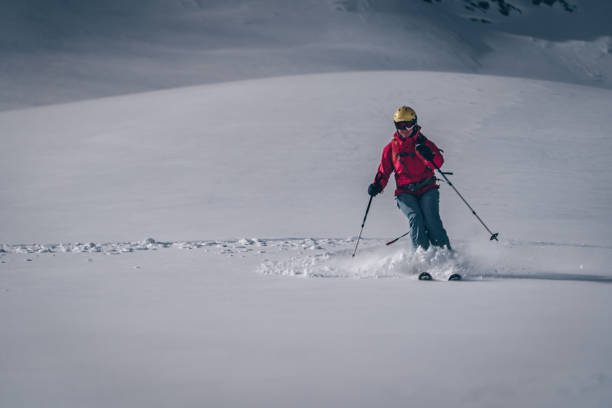 istock Female backcountry skier descends mountain 1218052894