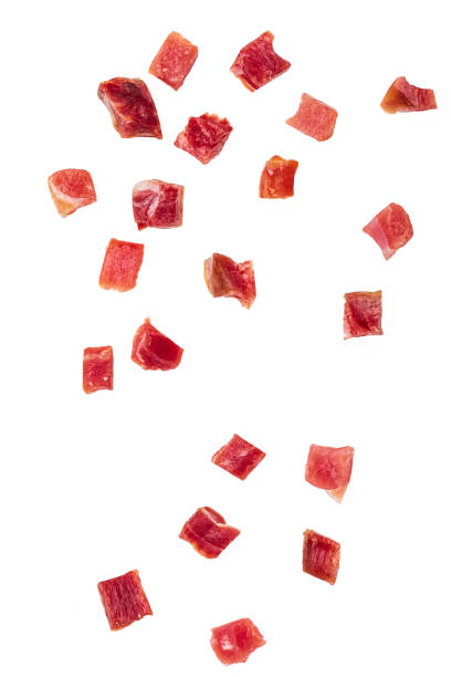 istock Iberian ham (serrano) cut into cubes (diced). Isolated on white background. 1218053513