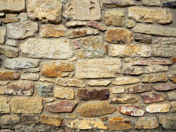istock Old castle wall, antique natural stone wall. Pattern gray color, decorative uneven cracked real stone wall surface with cement. 1218053647