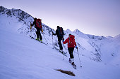 Backcountry skiers ascend mountain