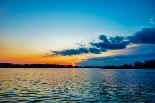 Sun on the Horizon with Clouds at Lake