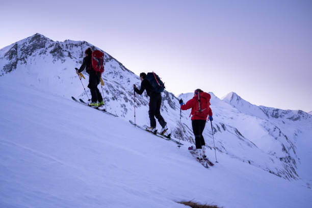 istock Backcountry skiers ascend mountain ridge 1218053763