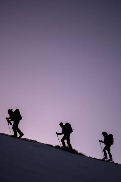 istock Backcountry skiers ascend mountain ridge 1218053818