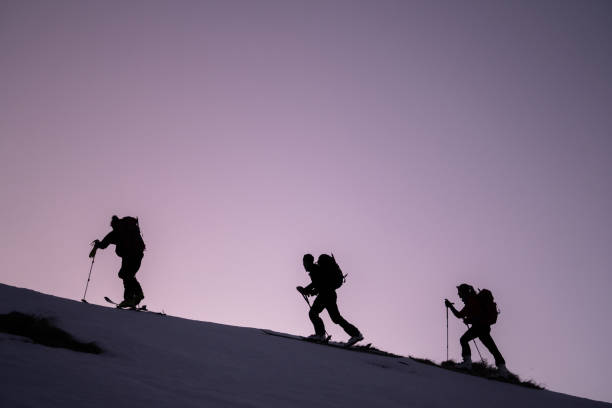 istock Backcountry skiers ascend mountain ridge 1218053820