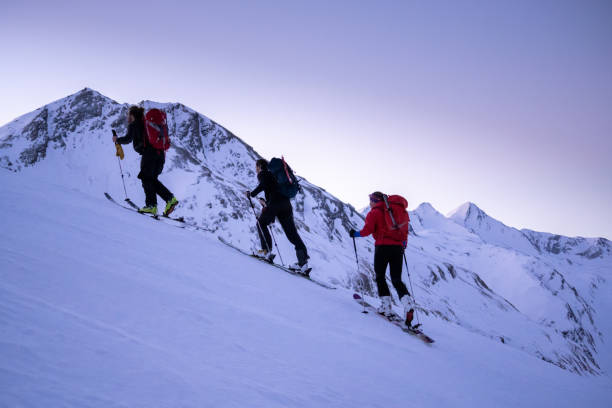 istock Backcountry skiers ascend mountain ridge 1218053839