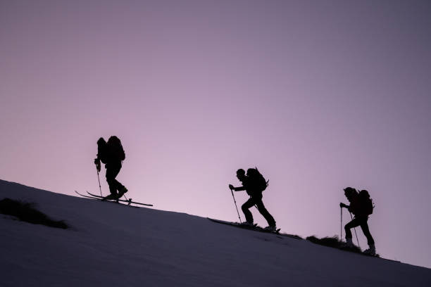 istock Backcountry skiers ascend mountain ridge 1218053840
