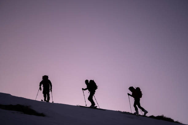 istock Backcountry skiers ascend mountain ridge 1218053866