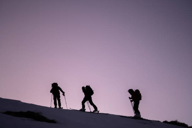 istock Backcountry skiers ascend mountain ridge 1218053875