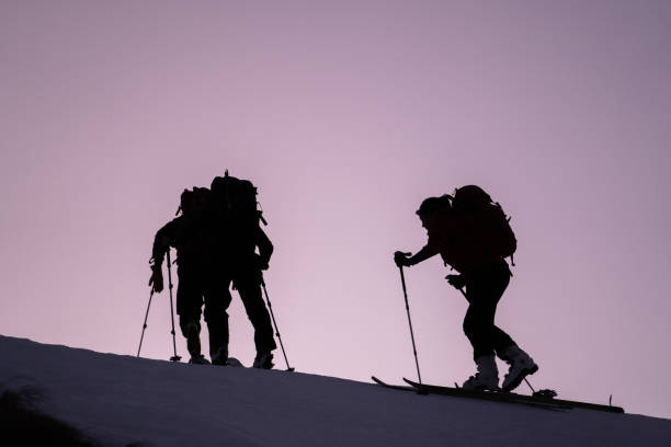 istock Backcountry skiers ascend mountain ridge 1218053889