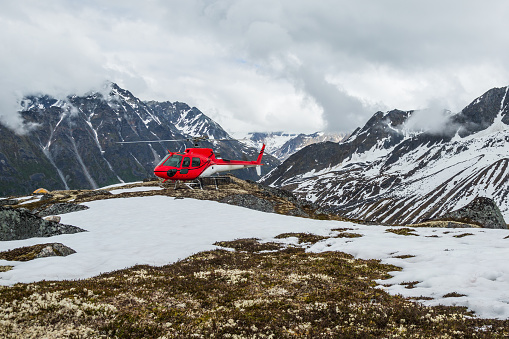 Helicopter landed on the tundra in the remote backcountry in the Talkeetna Mountain Range. Helicopter access to Alaskan wilderness.