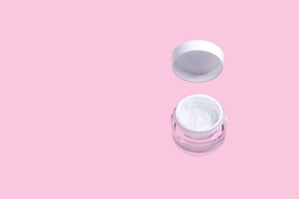 istock Open jar with cosmetic cream levitate on pink background 1218062377
