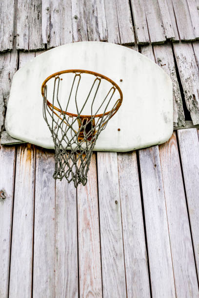 istock Old Rusty Basketball Backboard On Wooden Wall 1218062967
