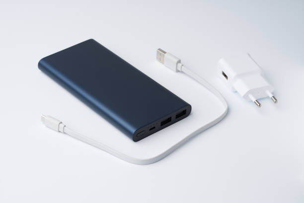 istock White USB power adapter, cable and blue power bank for divice isolated on a white background. 1218065154